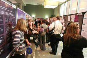 students and faculty viewing posters