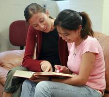2 students viewing a book