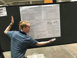student presenting poster on research day