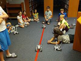 Children playing with robotics vehicles